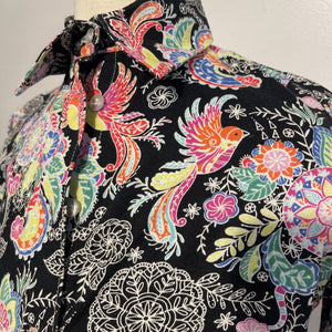 Black shirt w/ a bright floral pattern